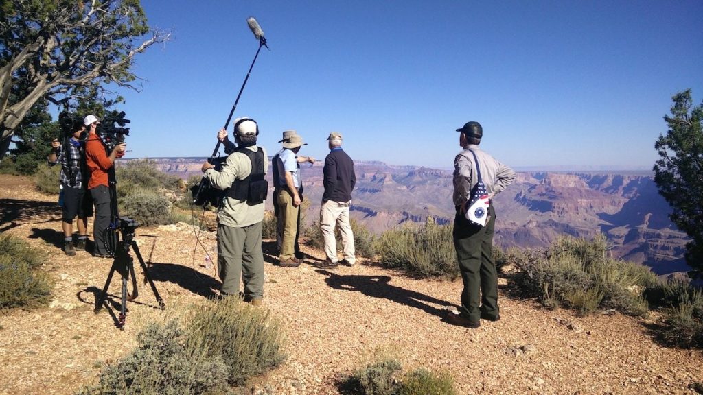 A film crew recording scientists at the rim of the Grand Canyon